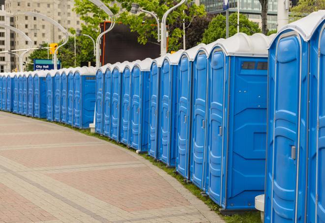 a row of portable restrooms at a fairground, offering visitors a clean and hassle-free experience in ambridge